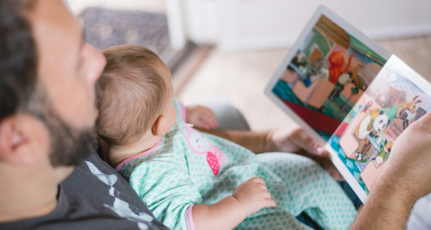 Father and child reading together
