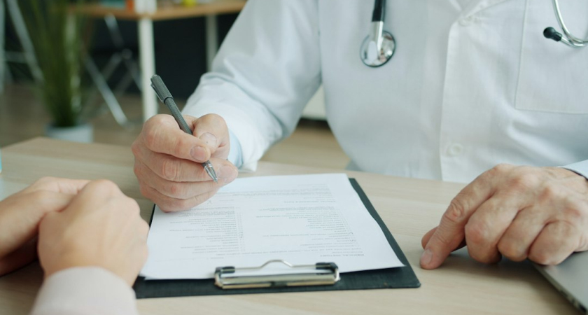 Healthcare professional discussing records with a patient