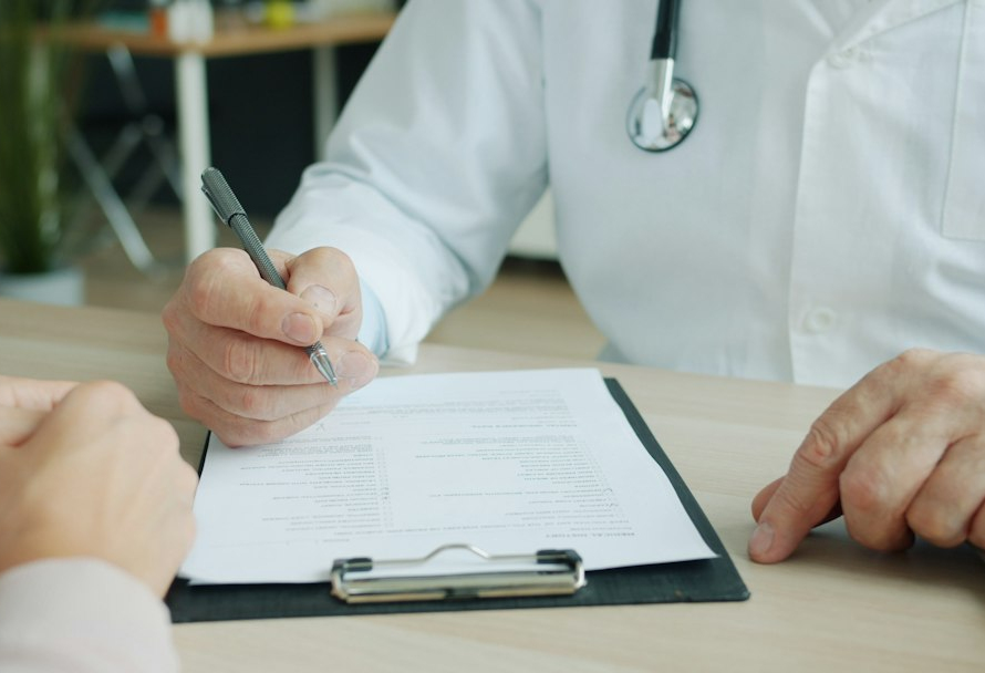 Healthcare professional discussing records with a patient