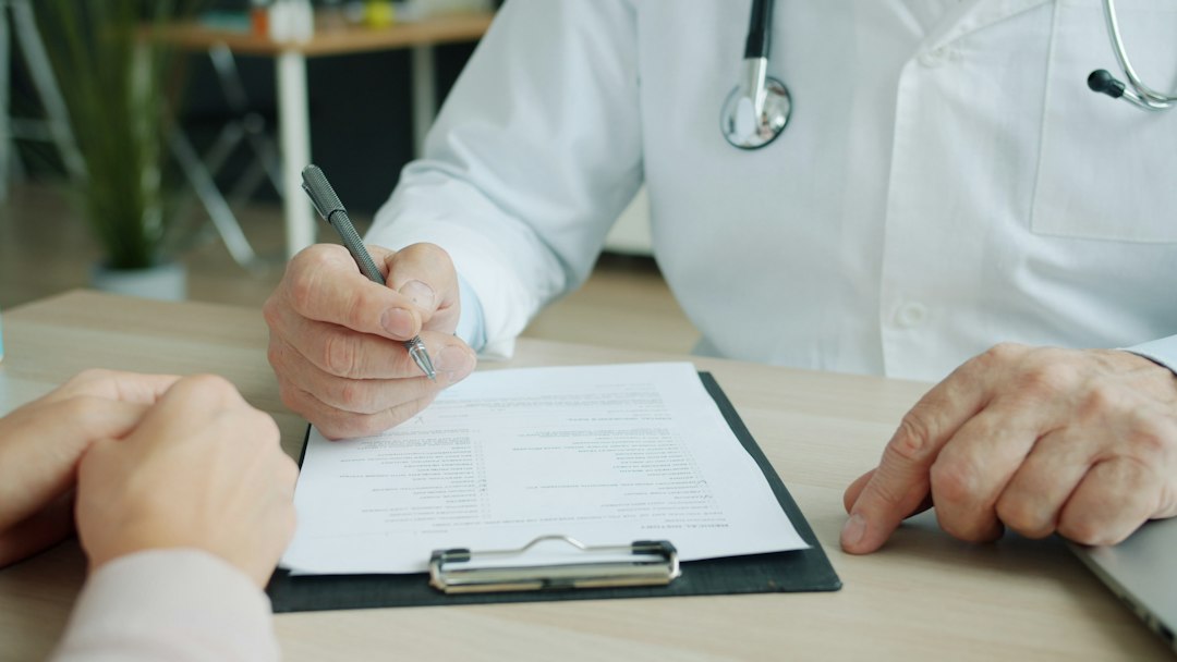 Healthcare professional discussing medical records with a patient