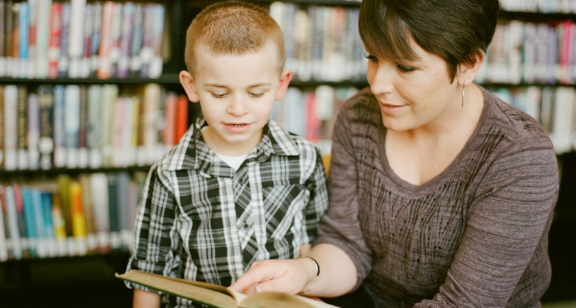 Mother and child reading a book together