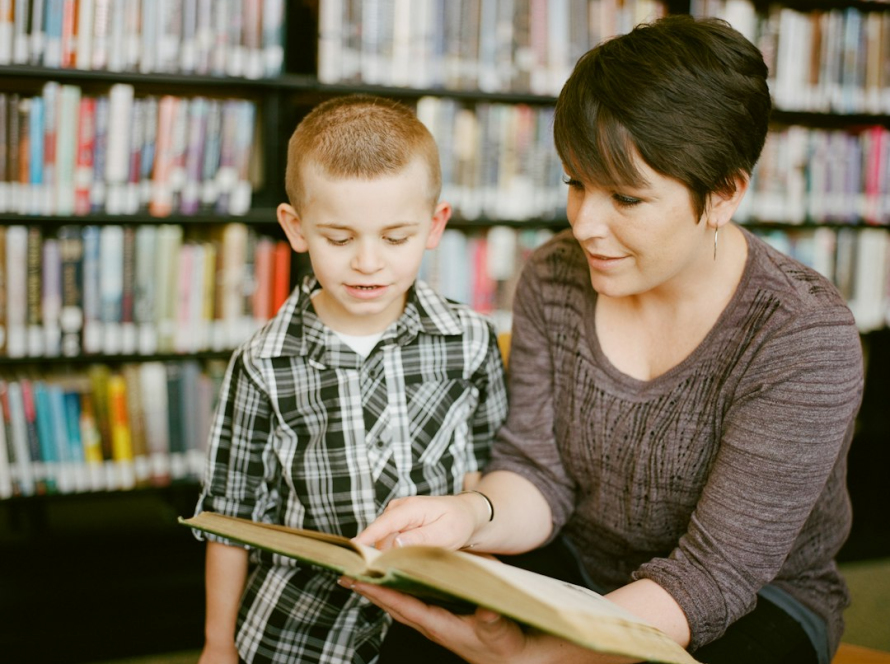 Mother and child reading a book together