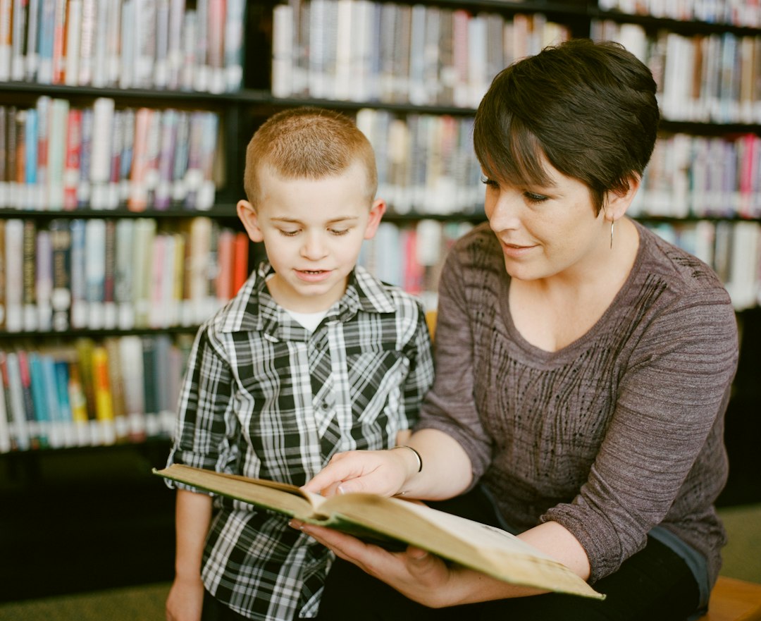 Mother and child reading together while supporting child personality and learning